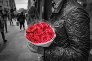 man holding red rose